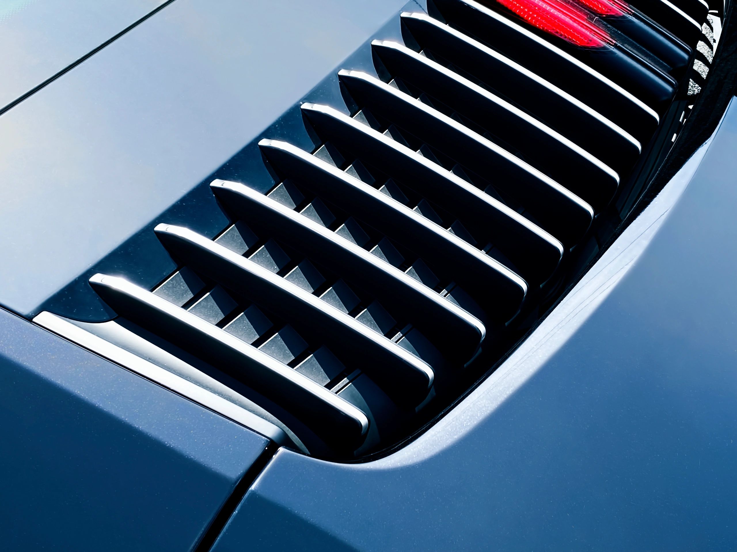 Modern sports car rear detail photographed in dramatic light