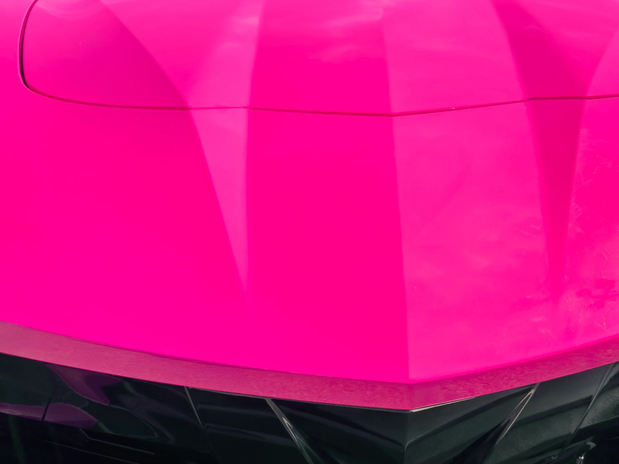 Close-up of a luxury sports car hood with sharp design lines